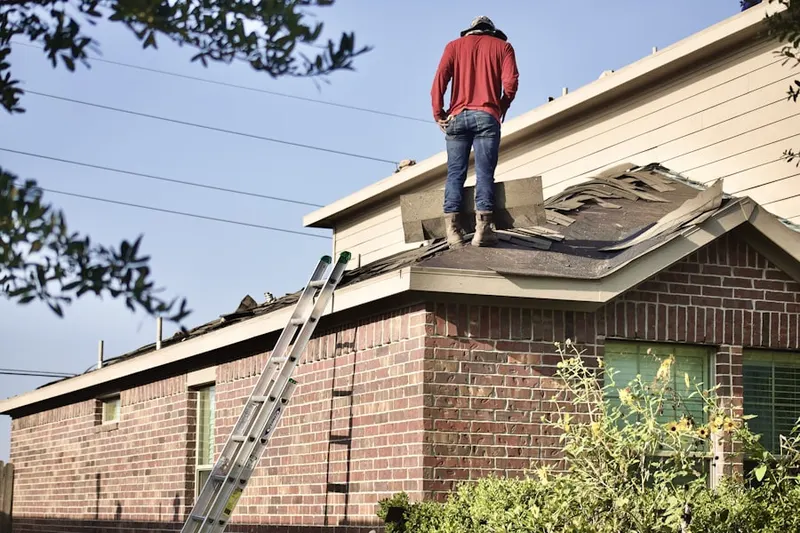 Professional roofer working on a residential roof in Montclair